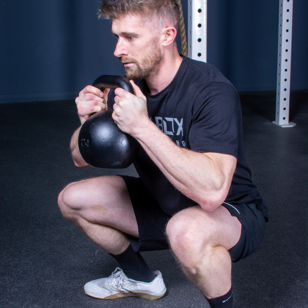 utility cast iron kettlebell in use squat